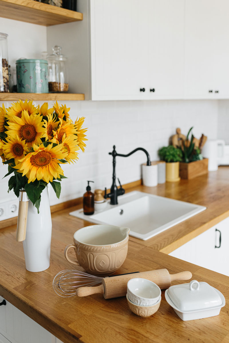 sink on a kitchen table with flowers